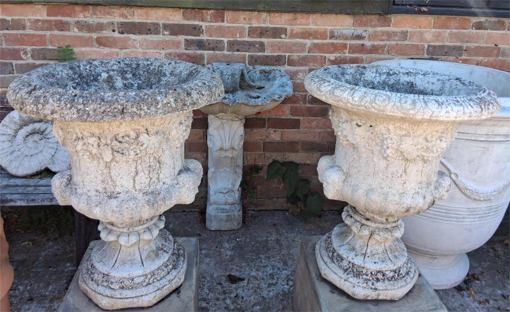 <p>Pair weathered Urns</p><p>67cm high x 54cm wide